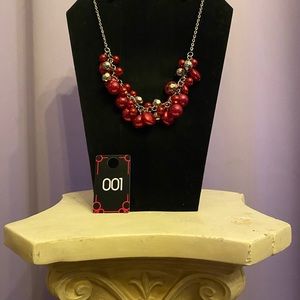 Costume jewelry. This fun, short necklace includes the matching red earrings.